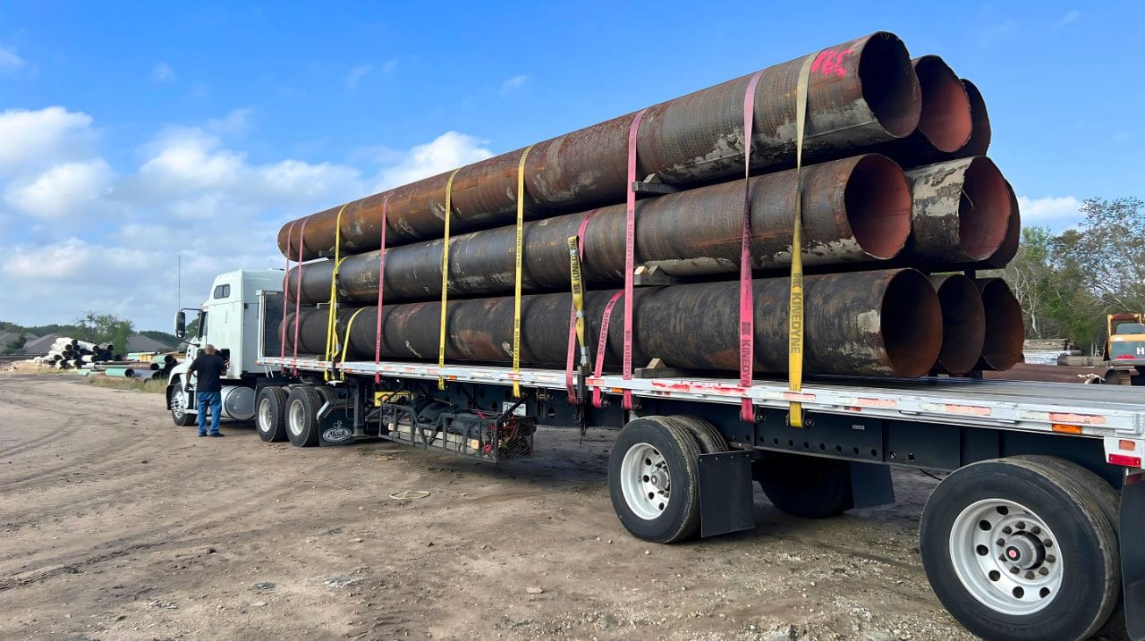 Pipe Coating Remediation | two men working on Pipe Coating Remediation of in ground pipeline